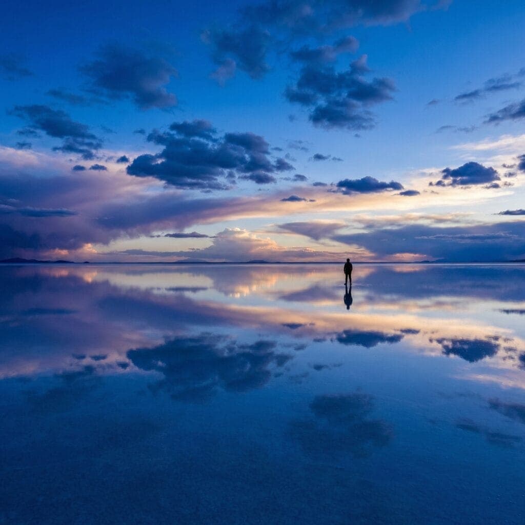 Pôr do sol no salar com lagunas espelhadas
